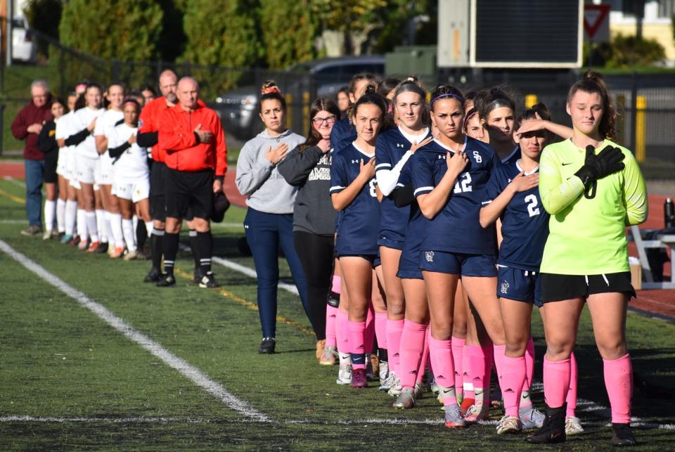 The Joseph Case and Somerset Berkley girls soccer team reflect during the national anthem prior to Wednesday's annual Cabral Cup at Somerset Berkley.