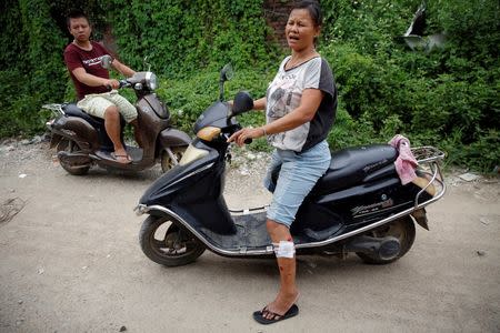 A woman who claimed injured during the violence on Tuesday rides a scooter in Wukan, Guangdong province, China, September 14, 2016. REUTERS/Damir Sagolj