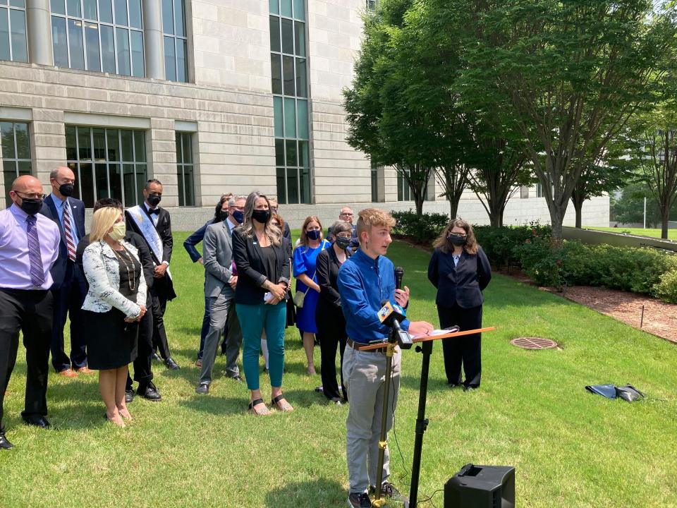 Dylan Brandt speaks at a news conference outside the federal courthouse in Little Rock, Ark., July 21, 2021. Brandt, a teenager, is among several transgender youth and families who are plaintiffs challenging a state law banning gender confirming care for trans minors.