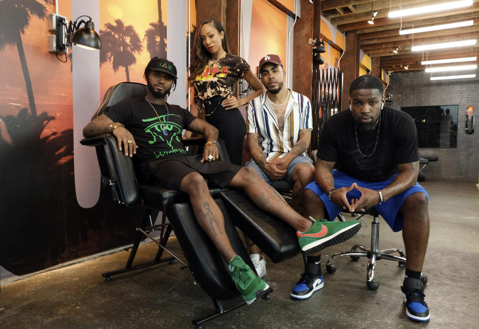 CORRECTS LAST NAME TO KIRKPATRICK FROM KILPATRICK This Aug. 15, 2019 photo shows, from left, Danny “KP” Kirkpatrick Erica "Barbie" Thompson, Christian "Ink Drippin'" Thomas and Timothy "Tim" Simmons, cast members in the reality television series "Black Ink Crew: Compton," at the IAM Compton tattoo shop in Compton, Calif. The show, which airs Wednesdays on VH1, follows the cast who attempt to create a “safe zone” in one of the tougher cities in California. The reality series is the third spinoff of the “Black Ink Crew” franchise. (Photo by Chris Pizzello/Invision/AP)