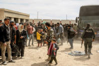 People are seen evacuated by Syrian forces from eastern Ghouta in Saqba, Syria, March 18, 2018. SANA/Handout via REUTERS ATTENTION EDITORS - THIS IMAGE HAS BEEN SUPPLIED BY A THIRD PARTY. REUTERS IS UNABLE TO INDEPENDENTLY VERIFY THIS IMAGE.