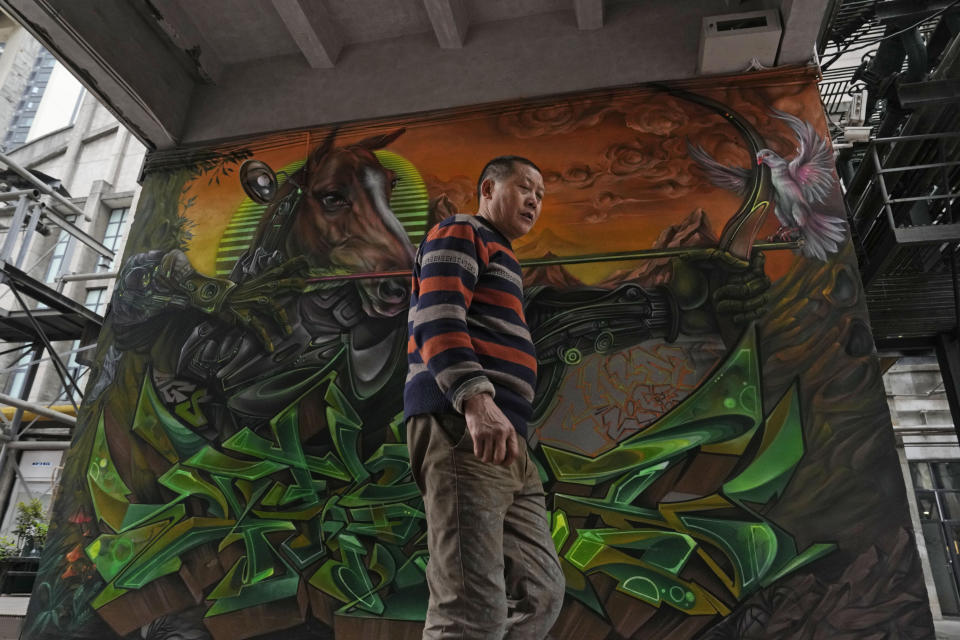 A man walks past graffiti art at a trendy district popular with youths in Chengdu, the capital of the southwestern China's Sichuan province, Sunday, March 17, 2024. Sichuan has come to dominate in the industry as rap has gone mainstream, with the region's dialect lending itself to rhymes and some of the biggest acts coming from the region. (AP Photo/Ng Han Guan)