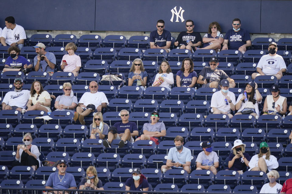 Fans watch during the fourth inning of a spring baseball game between the New York Yankees and the Toronto Blue Jays at George M. Steinbrenner Field, Sunday, Feb. 28, 2021, in Tampa, Fla. (AP Photo/Frank Franklin II)