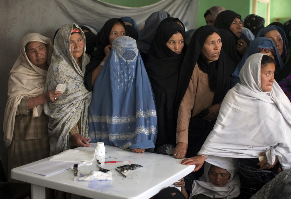 Afghan women wait to vote at a polling station during parliamentary elections in Kabul