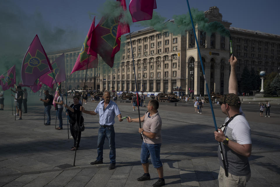 People light torches during a protest calling for the release of Ukrainian soldiers captured by Russians at the Independence Square in Kyiv, Ukraine, Sunday, Aug. 27, 2023. The protest marks five hundred days since the soldiers were captured in the besieged city of Mariupol. (AP Photo/Bram Janssen)