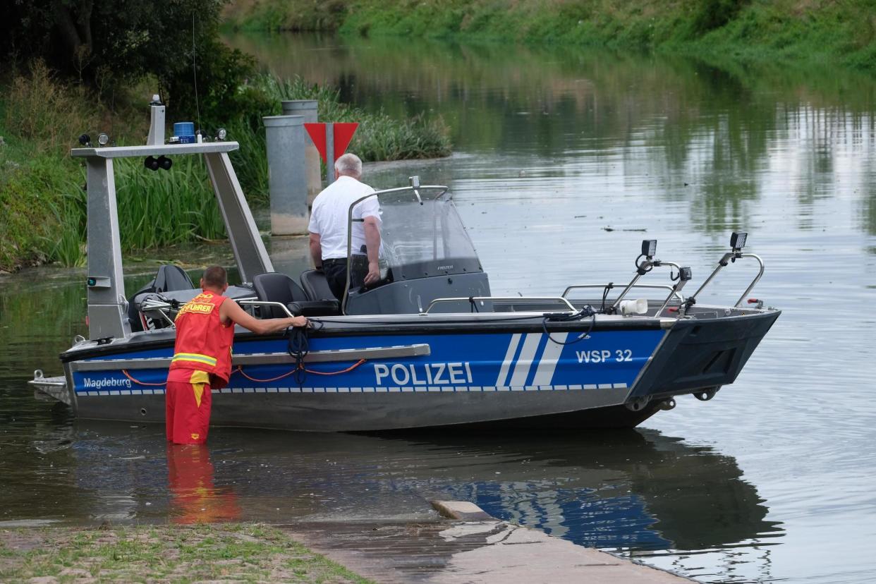 A boat of the water police is let into the river Unstrut in Troebsdorf, Germany on Saturday: AP