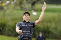 Jordan Spieth tosses his ball to his caddie after making a hole-in-one on the second hole during the third round of the Arnold Palmer Invitational golf tournament Saturday, March 6, 2021, in Orlando, Fla. (AP Photo/John Raoux)