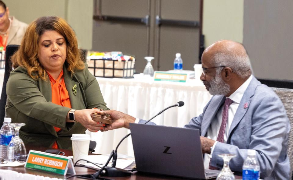 New Chair of the Board of Trustees Kristin Harper accepts the gavel from President Larry Robinson as Florida A&M BOT hold Committee Meetings on Thursday Oct, 12, 2023.