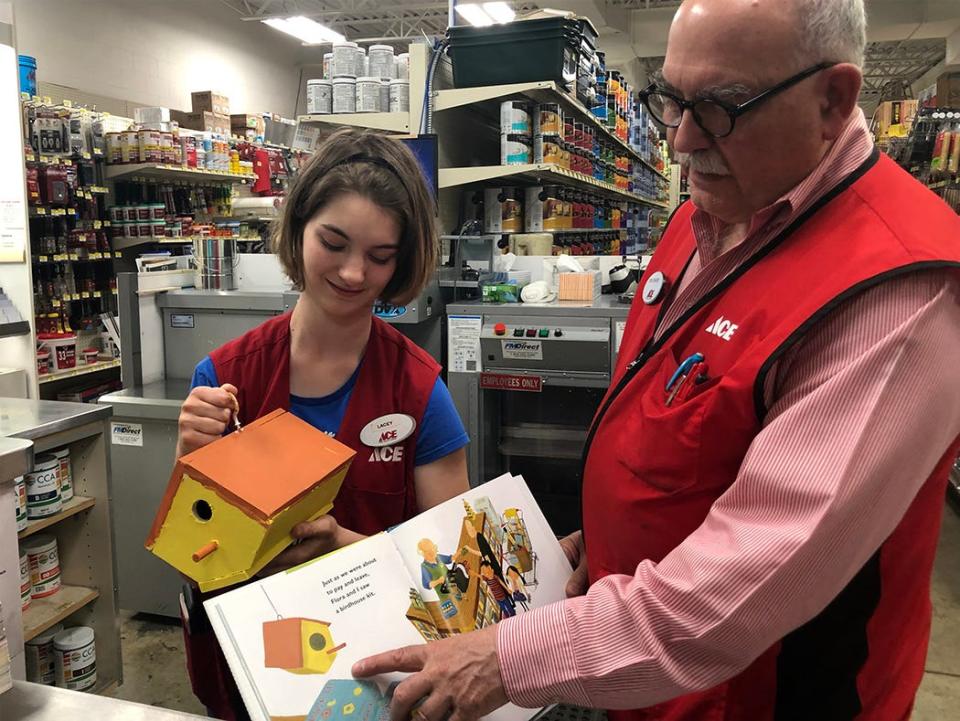 Lacey Richcreek and Tom Edwards show off the birdhouse that Lacey painted to go along with the “Let’s Go to the Hardware Store” books that children receive when they visit Auer Ace Hardware in this 2019 Tribune file photo.