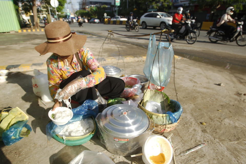 A Cambodian vendor prepares noodle for selling near a construction site, in Phnom Penh, Cambodia, Sunday, June 9, 2019. The bitter decadeslong rivalry between Hun Sen, Cambodia's strongman leader, and Sam Rainsy, the self-exiled chief political rival and critic, has sometimes played out in deadly violence. But on Sunday, soup rather than blood was likely to be spilled. (AP Photo/Heng Sinith)