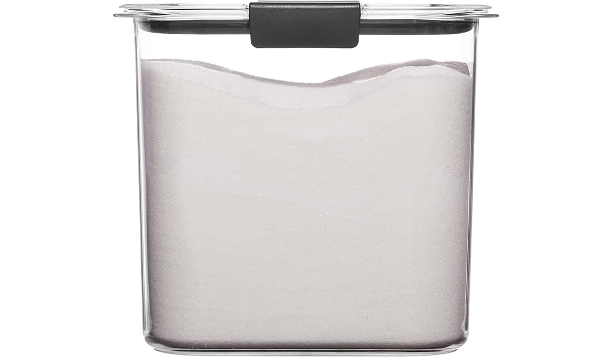 A clear plastic container filled with sugar