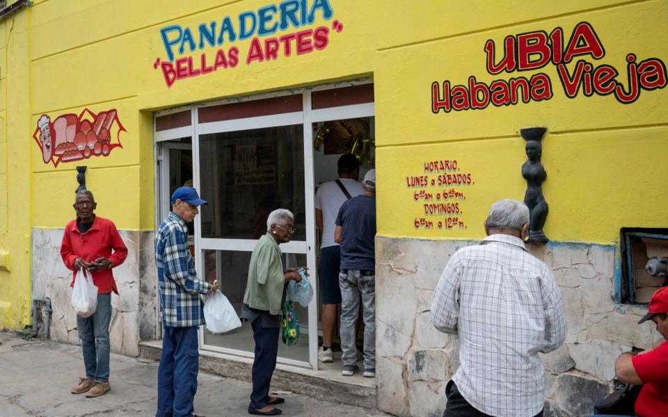 Elderly people queue to buy bread at a bakery in Havana amid a shortage of food