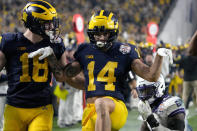 Michigan wide receiver Roman Wilson (14) celebrates his touchdown with tight end Colston Loveland (18) against TCU during the second half of the Fiesta Bowl NCAA college football semifinal playoff game, Saturday, Dec. 31, 2022, in Glendale, Ariz. (AP Photo/Rick Scuteri)