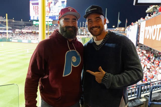 <p>Gabriella Ricciardi/MLB Photos via Getty </p> Jason and Travis Kelce pose for a photo during Game 1 of the NLCS between the Arizona Diamondbacks and the Philadelphia Phillies at Citizens Bank Park on Monday, October 16, 2023 in Philadelphia, Pennsylvania.