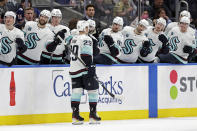 Seattle Kraken defenseman Vince Dunn reacts with teammates after scoring a goal in the third period of an NHL hockey game against the New York Islanders on Wednesday, Feb. 2, 2022, in Elmont, N.Y. The Kraken won 3-0. (AP Photo/Adam Hunger)