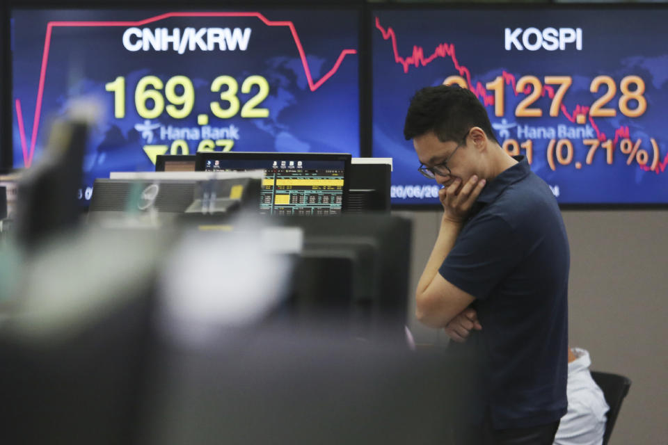 A currency trader works at the foreign exchange dealing room of the KEB Hana Bank headquarters in Seoul, South Korea, Friday, June 26, 2020. Asian stock markets followed Wall Street higher on Friday after U.S. regulators removed some limits on banks' ability to make investments. (AP Photo/Ahn Young-joon)
