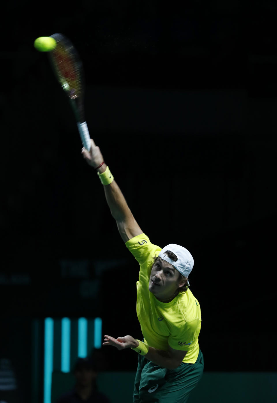 Australia's Alex de Minaur serves to Netherland's Botic van de Zandschulp during a Davis Cup quarter-final tennis match between Australia and The Netherlands in Malaga, Spain, Tuesday, Nov. 22, 2022. (AP Photo/Joan Monfort)