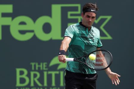 Apr 2, 2017; Key Biscayne, FL, USA; Roger Federer of Switzerland hits a backhand against Rafael Nadal of Spain (not pictured) in the men's singles championship of the 2017 Miami Open at Crandon Park Tennis Center. Mandatory Credit: Geoff Burke-USA TODAY Sports