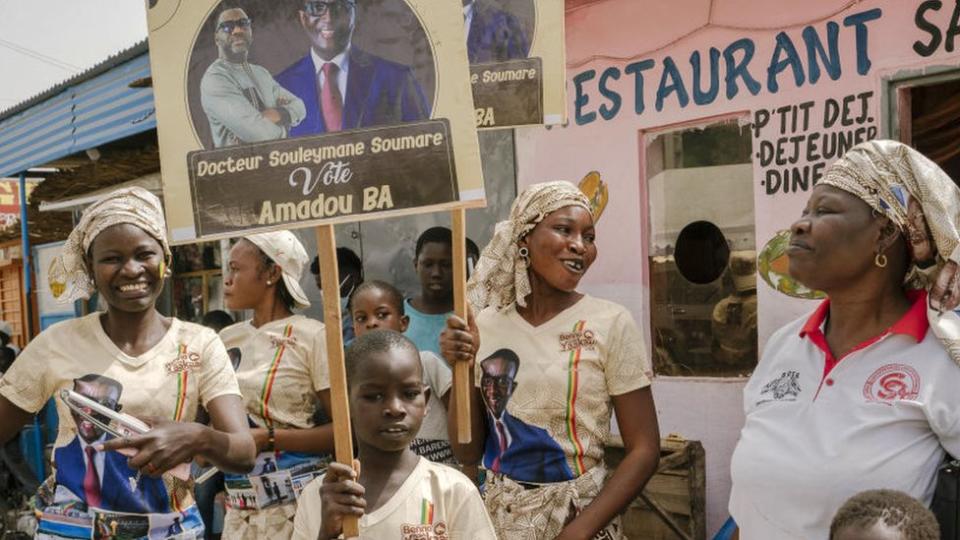 Supporters hold placards before a campaign meeting of Amadou Ba, candidate of the Alliance For the Republic party (APR) in Diourbel, Senengal - 19 March 2024