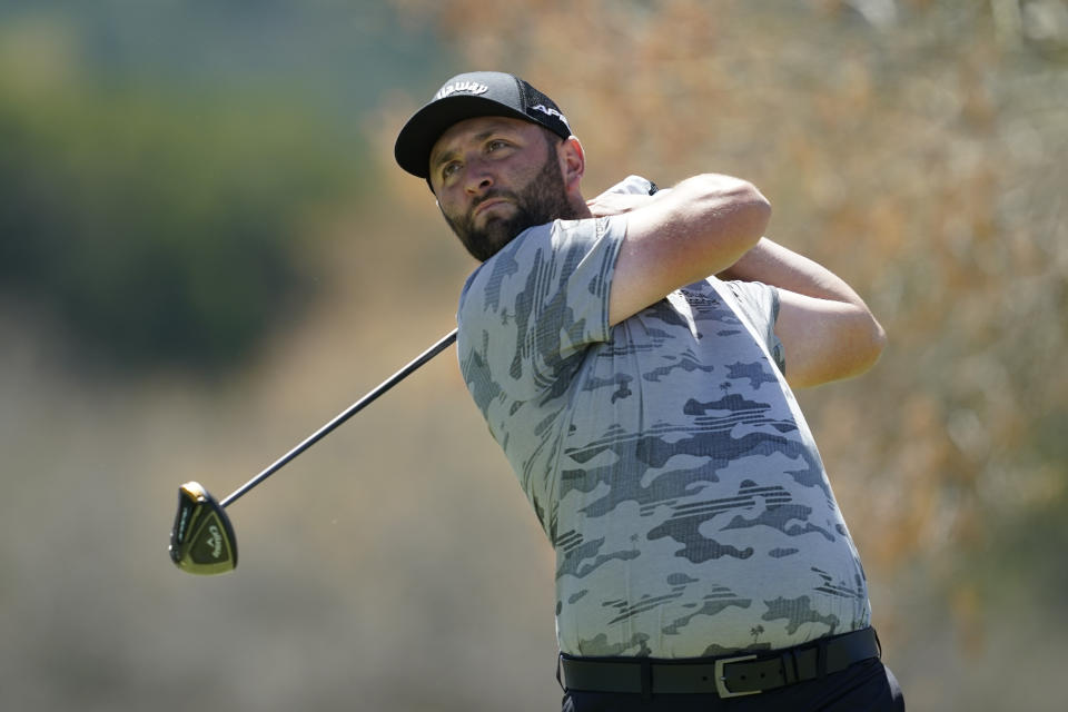 Jon Rahm watches his shot from the sixth tee during the third round of the Dell Technologies Match Play Championship golf tournament, Friday, March 25, 2022, in Austin, Texas. (AP Photo/Tony Gutierrez)