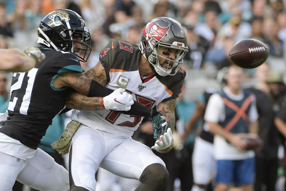 Jacksonville Jaguars cornerback A.J. Bouye (21) breaks up a pass intended for Tampa Bay Buccaneers wide receiver Mike Evans (13) during the first half of an NFL football game, Sunday, Dec. 1, 2019, in Jacksonville, Fla. (AP Photo/Phelan M. Ebenhack)