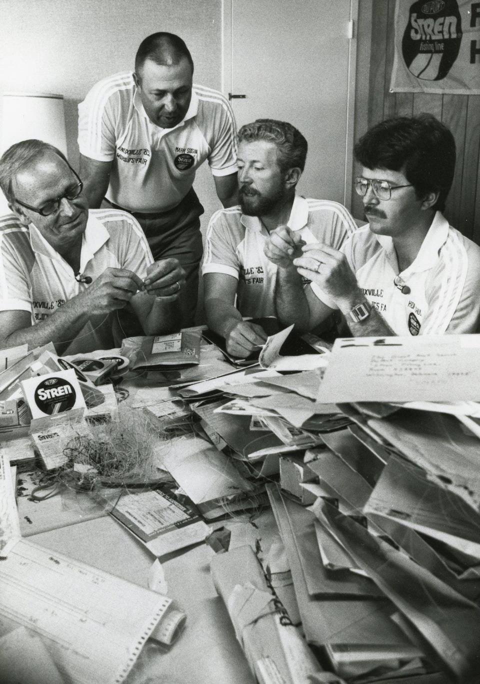 Vic Dunaway, Mark Sosin, Jerry Gibbs and Ken Schultz, from left, inspect some of the 500 entries in the World's Fair Stren Great Knot Search during the 1982 World's Fair in Knoxville.