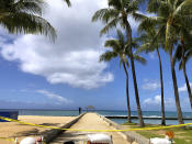 A man walks along a closed pier on Waikiki Beach in Honolulu on Saturday, March 28, 2020. Like many cities across the world, Honolulu came to an eerie standstill this weekend as the coronavirus pandemic spread throughout the islands. But Hawaii officials went beyond the standard stay-at-home orders and effectively flipped the switch on the state's tourism-fueled economic engine in a bid to slow the spread of the virus. As of Thursday, anyone arriving in Hawaii must undergo a mandatory 14-day self-quarantine. The unprecedented move dramatically reduced the number of people on beaches, in city parks and on country roads where many people rely on tourism to pay for the high cost of living in Hawaii. (AP Photo/Caleb Jones)