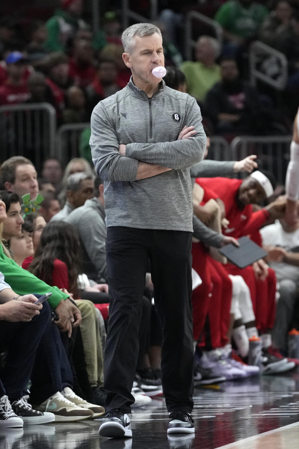 Chicago Bulls coach Billy Donovan blows a bubble as he watches play during the first half of the team's NBA basketball game against the Minnesota Timberwolves in Chicago, Friday, March 17, 2023. (AP Photo/Nam Y. Huh)