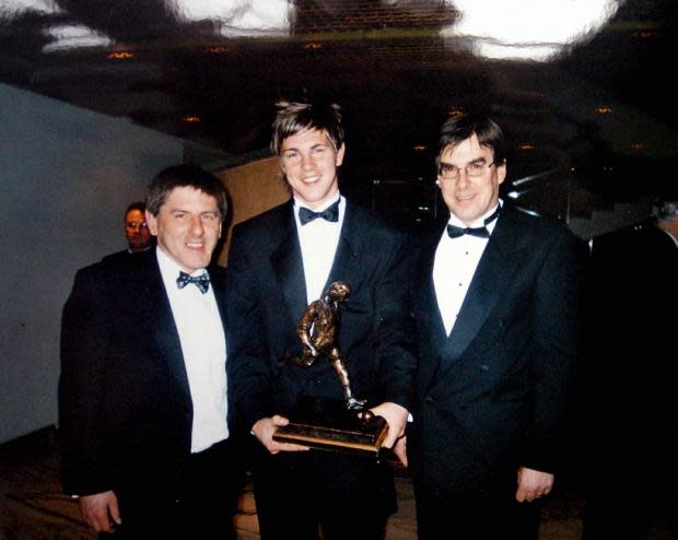 News and Star: Huntington with dad David, right, and Peter Beardsley, after receiving the 'Wor Jackie' trophy in 2005