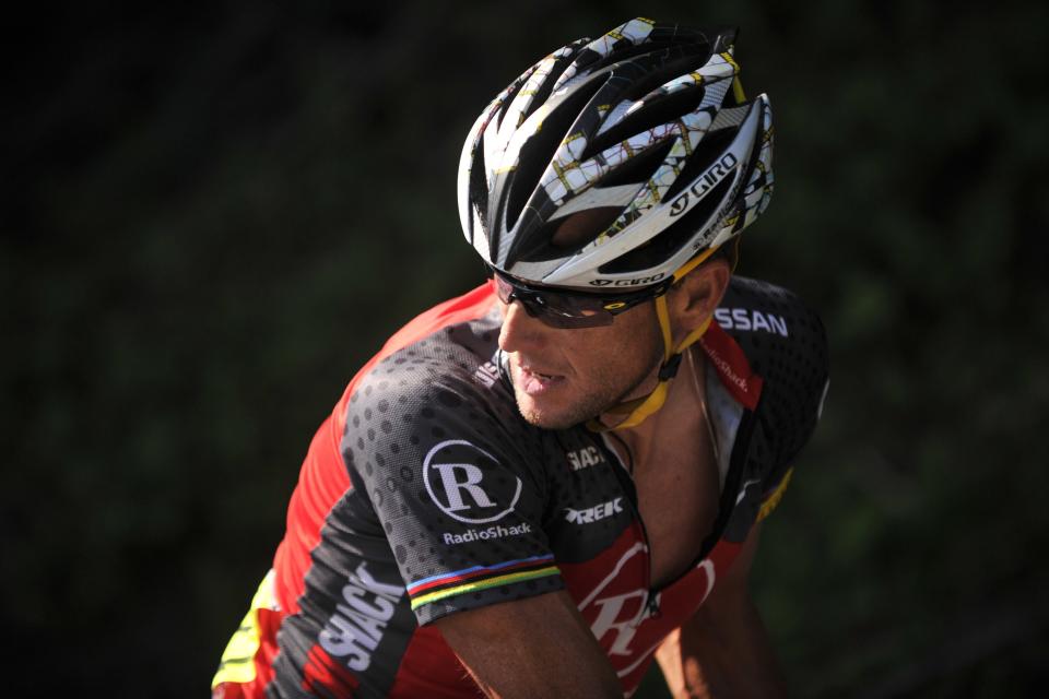 US Lance Armstrong looks back as he rides in a breakaway during the 199,5 km and 16th stage of the 2010 Tour de France cycling race run between Bagneres-de-Luchon and Pau, Southwestern France,  on July 20, 2010.   AFP PHOTO / LIONEL BONAVENTURE (Photo credit should read LIONEL BONAVENTURE/AFP/Getty Images)