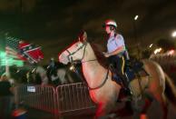 <p>New Orleans Police mounted patrol officers keep watch over a crowd that gathered to watch the removal of a statue of Confederate Gen. P.G.T. Beauregard Wed., May 17, 2017, from the entrance to City Park in New Orleans. (Photo: Scott Threlkeld/AP) </p>