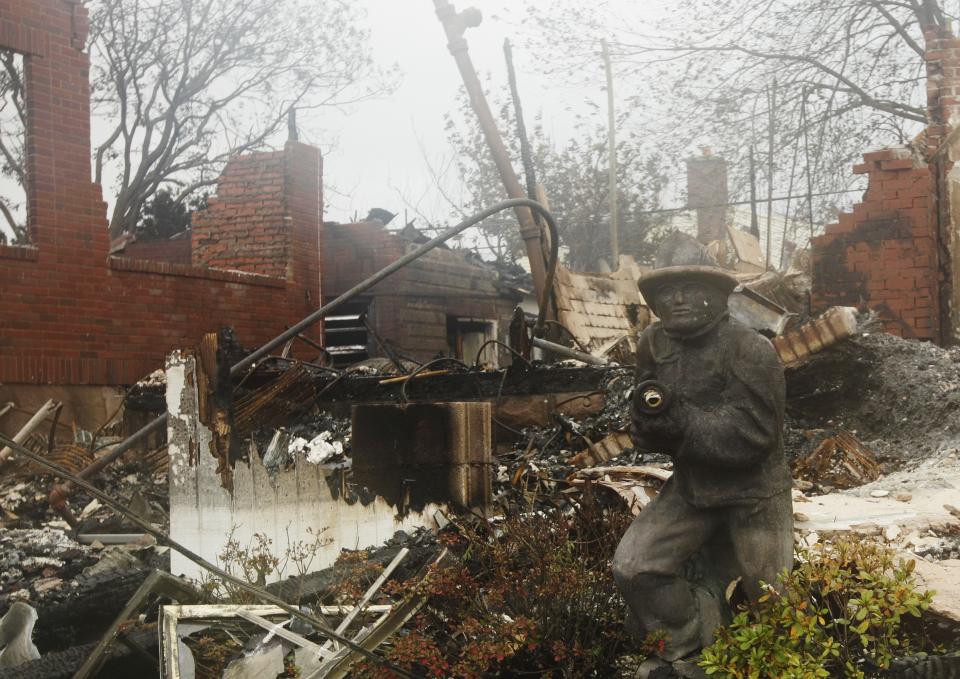 A home damaged by fire is shown in the Belle Harbor neighborhood in the New York City borough of Queens Tuesday, Oct. 30, 2012, in New York. Sandy, the storm that made landfall Monday, caused multiple fatalities, halted mass transit and cut power to more than 6 million homes and businesses. (AP Photo/Frank Franklin II)