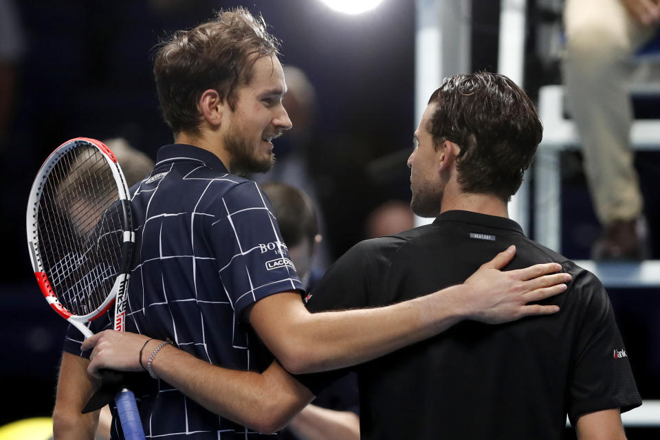 Daniil Medvedev of Russia, left, puts his arm around Dominic Thiem of Austria after he wins their singles final tennis match at the ATP World Finals tennis tournament at the O2 arena in London, Sunday, Nov. 22, 2020. (AP Photo/Frank Augstein)
