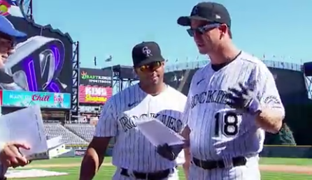 Peyton Manning and Russell Wilson take batting practice with the