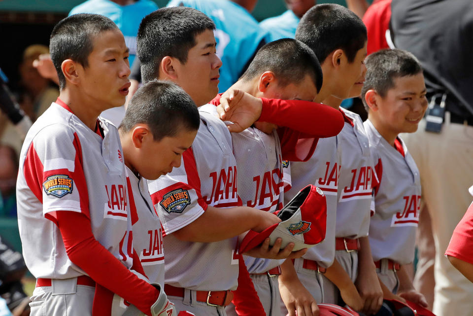 The Little League team from Japan lines up to salute their fans after a 5-4 loss to Curacao in the International Championship baseball game at the Little League World Series tournament in South Williamsport, Pa., Saturday, Aug. 24, 2019. (AP Photo/Gene J. Puskar)