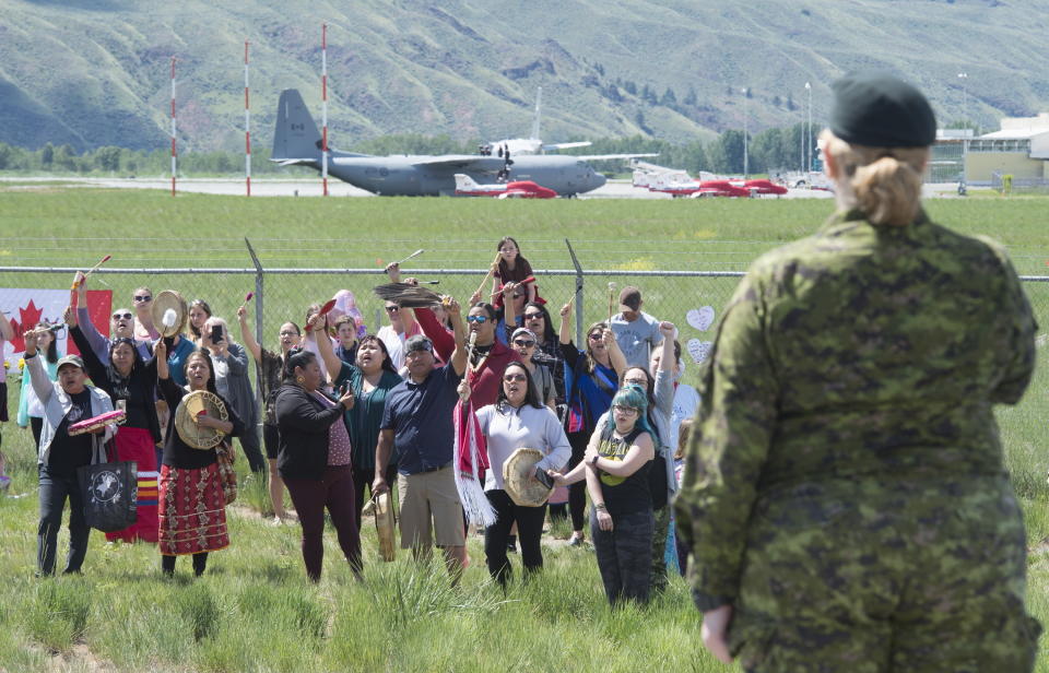 First Nations drummers salute Royal Canadian Air Force Public Affairs Officer Lt. Alexandra Hejduk during a drum ceremony to remember fallen Snowbirds Capt. Jenn Casey in Kamloops, B.C., Monday, May 18, 2020. Capt.Casey died Sunday after the Snowbirds jet she was in crashed shortly after takeoff. The pilot of the aircraft is in hospital with serious injuries. (Jonathan Hayward/The Canadian Press via AP)