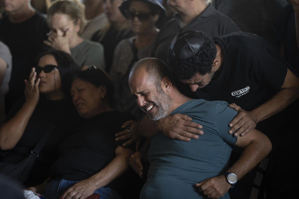 Mourners attend the funeral of the Israeli woman Shiraz Tamam, killed by Hamas militants while attending a music festival, at a cemetery in Holon, central Israel, Tuesday, Oct. 17, 2023. (AP Photo/Petros Giannakouris