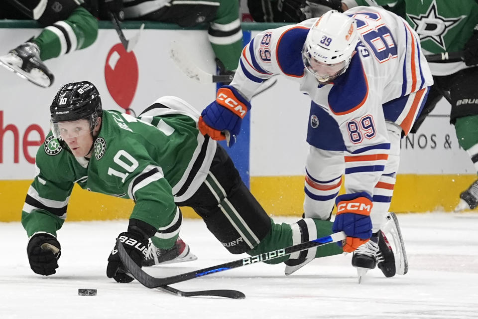 Dallas Stars center Ty Dellandrea (10) falls to the ice against Edmonton Oilers center Sam Gagner (89) during the first period an NHL hockey game in Dallas, Saturday, Feb. 17, 2024. (AP Photo/LM Otero)