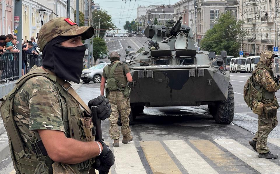 Fighters of Wagner private mercenary group stand guard in a street near the headquarters of the Southern Military District in the city of Rostov-on-Don
