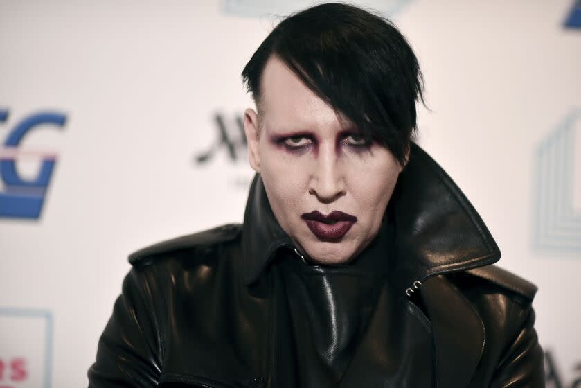 FILE - In this Dec. 10, 2019, file photo, Marilyn Manson attends the 9th annual "Home for the Holidays" benefit concert in Los Angeles. Detectives are investigating Manson for allegations of domestic violence that reportedly occurred about a decade ago in West Hollywood, authorities said. The domestic violence is believed to have occurred between 2009 and 2011, when Manson lived in the city of West Hollywood. (Photo by Richard Shotwell/Invision/AP, File)