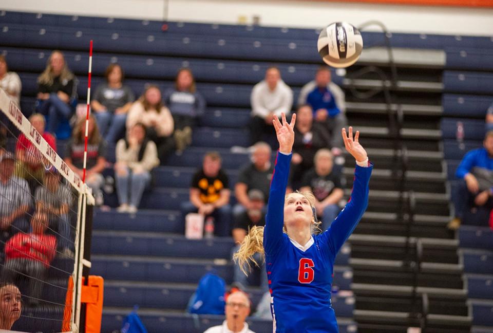 Highland's Larsen Terrill sets a teammate near the net.