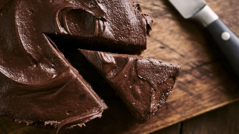 Close up of iced chocolate cake with a slice removed