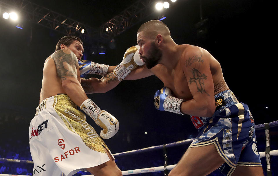 Tony Bellew, right, hits Oleksandr Usyk with a right during their cruiserweight boxing bout Saturday, Nov. 10, 2018, in Manchester, England. Usyk successfully defended his four belts and likely sent Bellew into retirement by knocking out the British fighter in the eighth round. (Nick Potts/PA via AP)