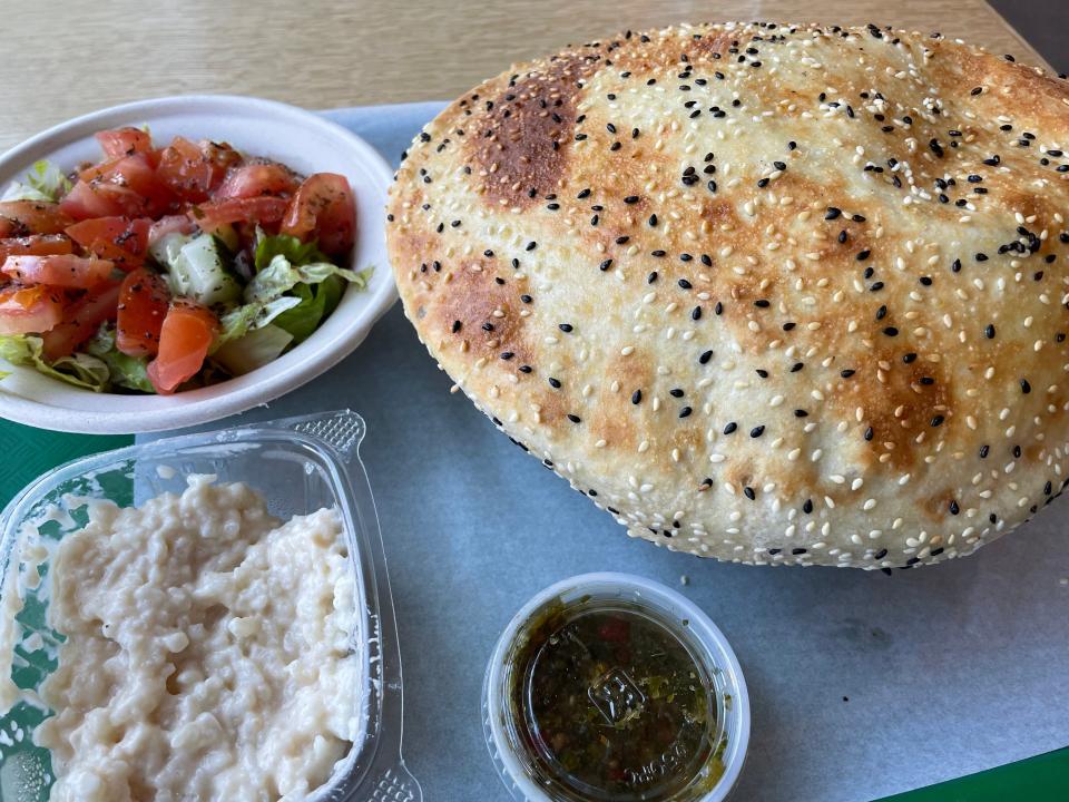 The Rom's Bowl at Rom's House at Marble City Market is served with a side salad, hot sauce and Afghan bread.