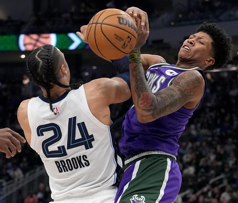 Memphis Grizzlies forward Dillon Brooks (24) strips the ball from Milwaukee Bucks forward MarJon Beauchamp (0) during the first half of their game Friday, April 7, 2023 at Fiserv Forum in Milwaukee, Wis.