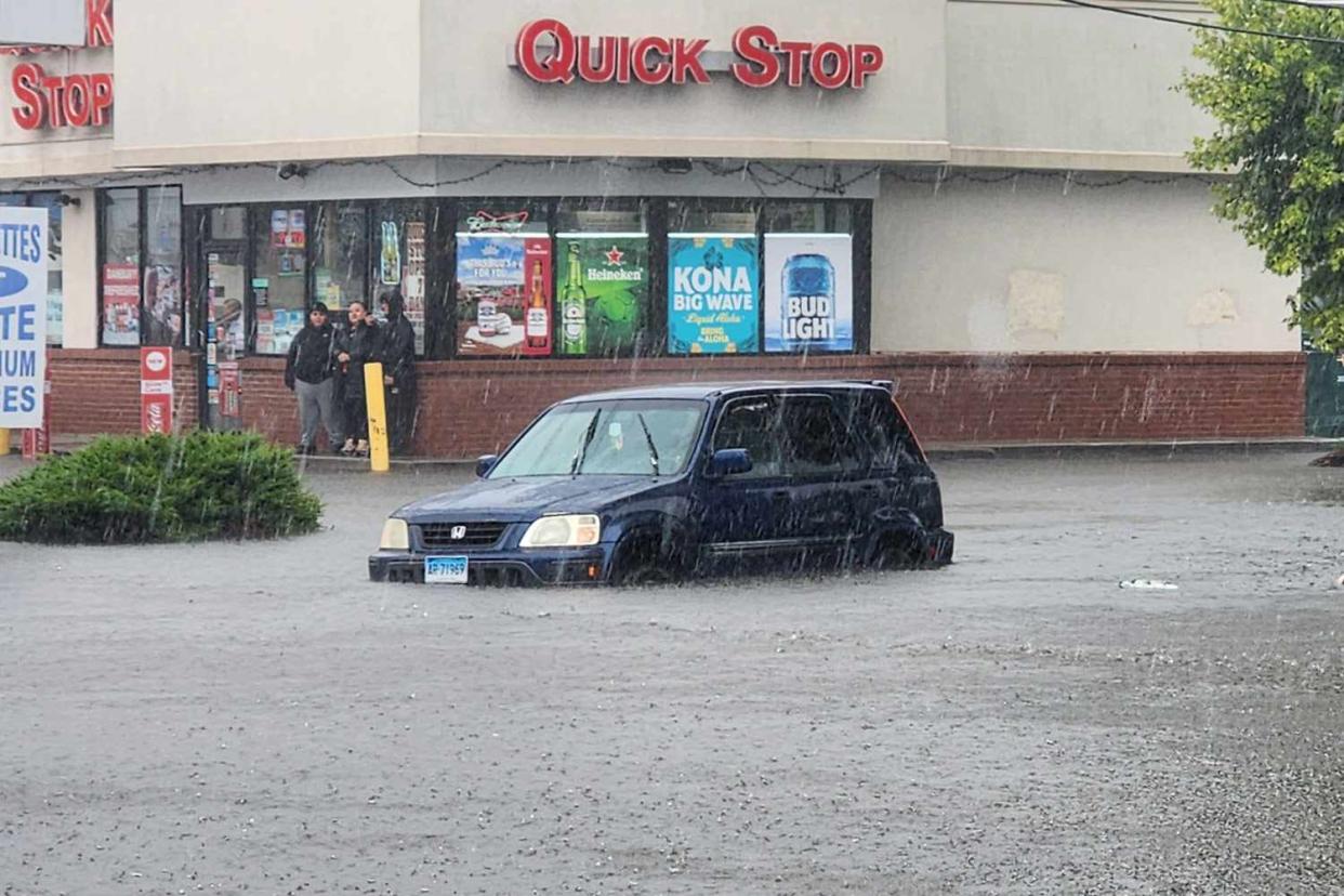 <p>Danbury Fire Department/Facebook</p> Floodwaters in Danbury, Conn., where at least one person has died following tropical downpours on Sunday, Aug. 18, 2024