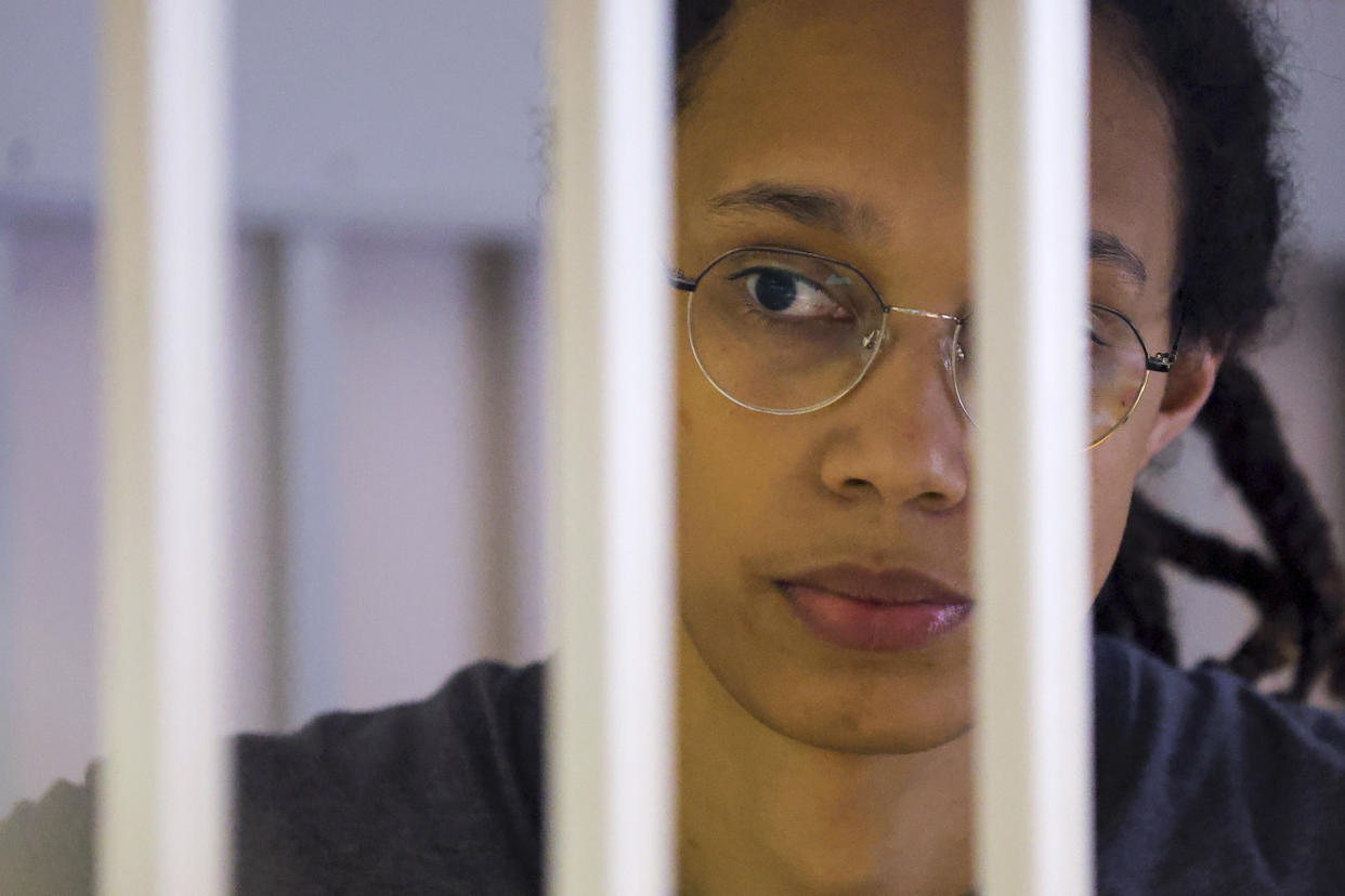 U.S. Basketball player Brittney Griner looks through bars as she listens to the verdict standing in a cage in a courtroom in Khimki, outside Moscow, Russia, Thursday, Aug. 4, 2022. (Evgenia Novozhenina/AP)