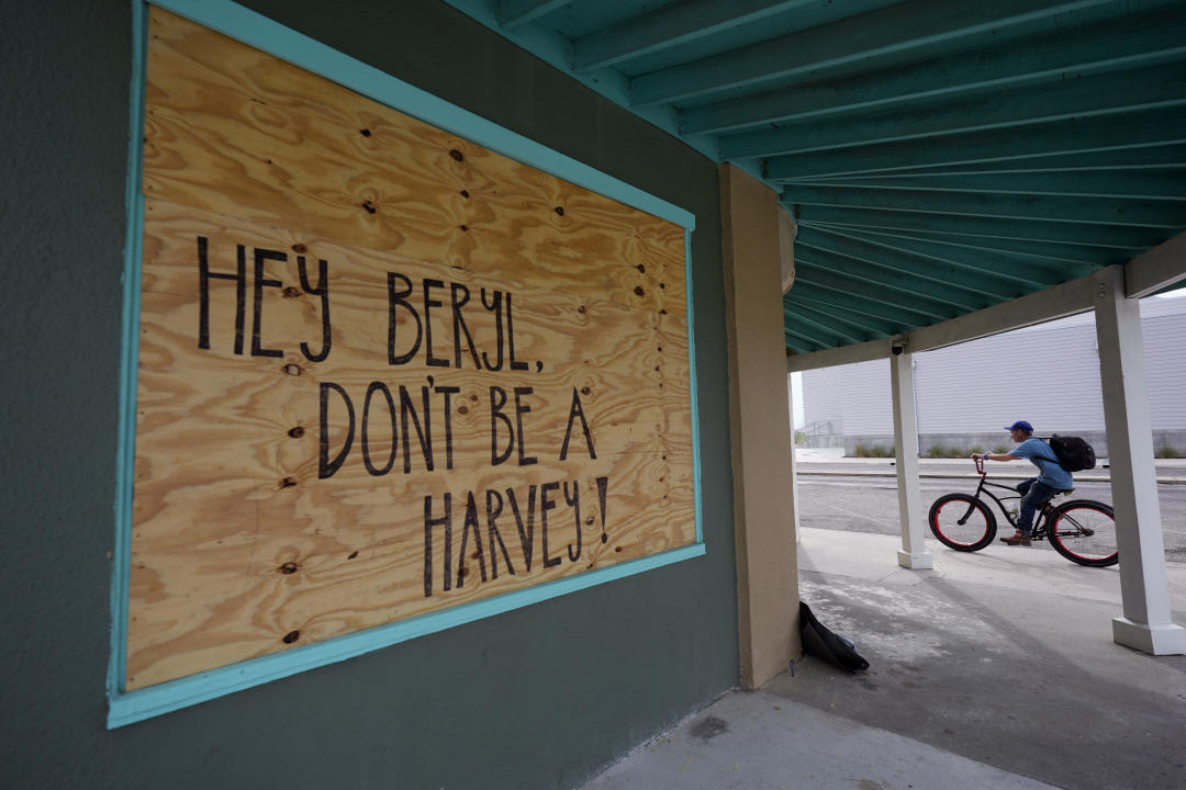 A message for Beryl left on a boarded-up business reads: Hey Beryl, don't be a Harvey!