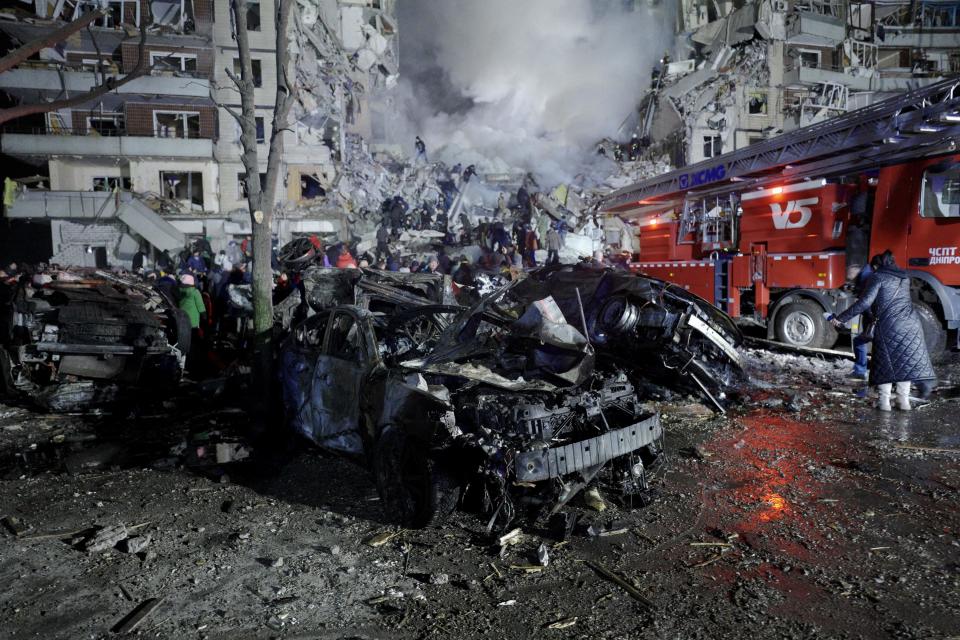 A car and a residential building that were destroyed by a Russian missile strike on the Ukrainian city of Dnipro on Jan. 14, 2023.  / Credit: VITALII MATOKHA/AFP/Getty Images