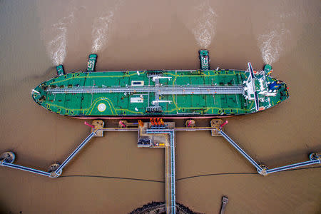 An oil tanker unloads crude oil at a crude oil terminal in Zhoushan, Zhejiang province, China July 4, 2018. Picture taken July 4, 2018. REUTERS/Stringer/File Photo